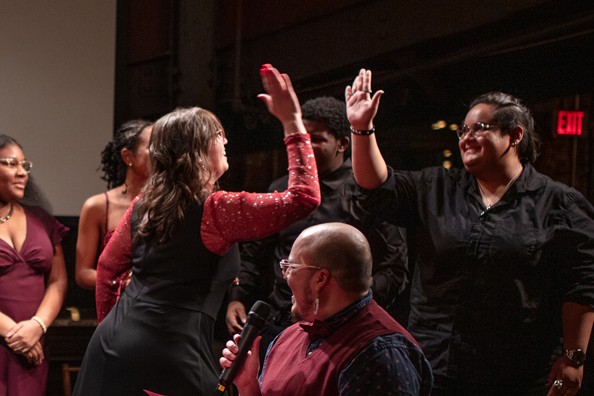 Storytellers high five after a performance